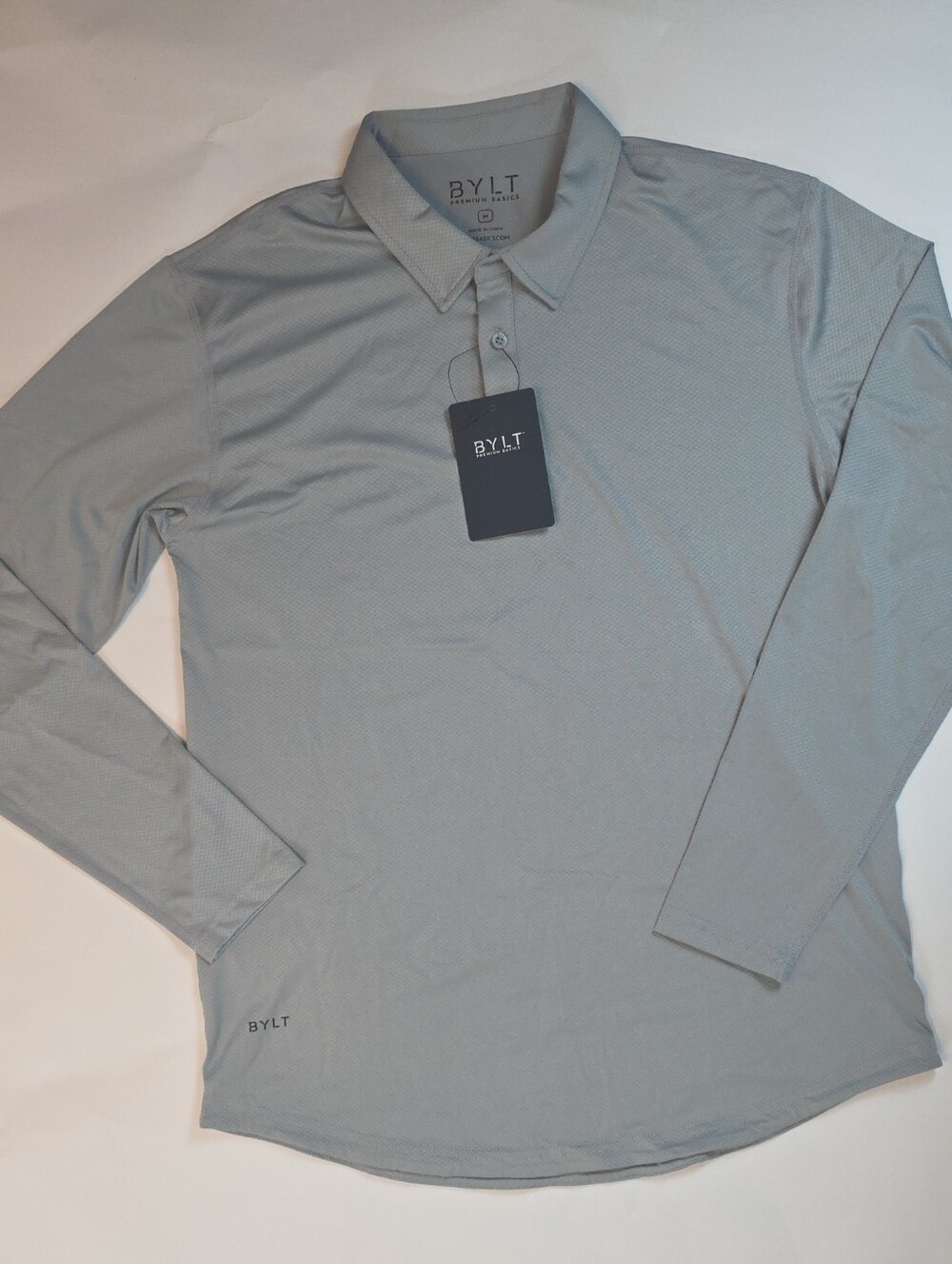NWT Men's BYLT Premium Basics Performance+ L/S Polo in color Storm. Size Medium